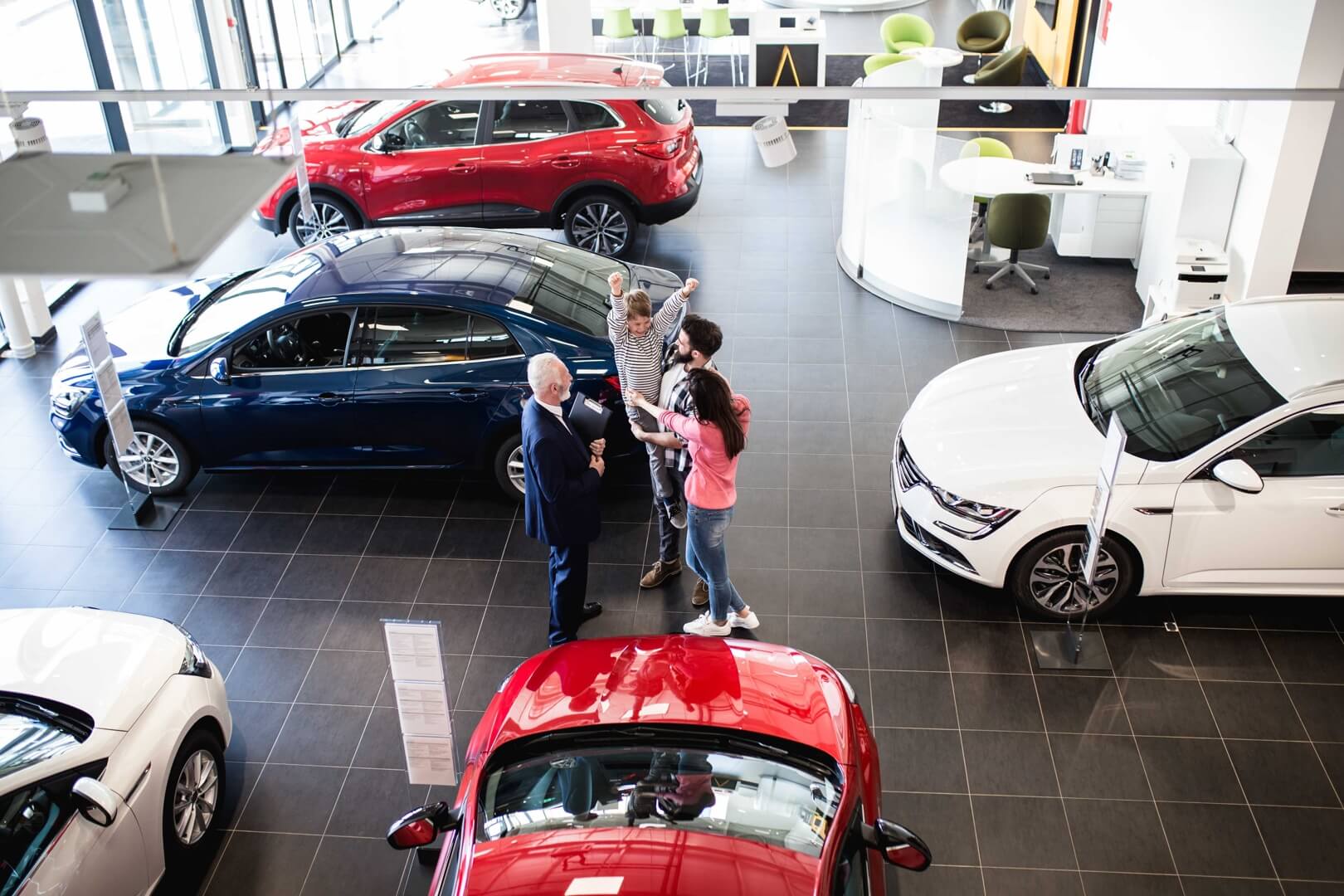 An excited family inside a car dealership